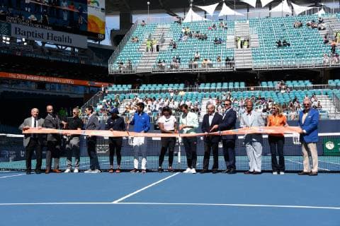 MIAMI GARDENS, FL - MARCH 20: James Blake-second from left, Novak Djokovic, 6th from left, Serena Williams, Roger Federer, Stephen Ross and Tom Garfinkel attend the ribbon cutting for Stadium Court at the Miami Open on March 20, 2019 at Hard Rock Stadium in Miami Gardens, FL. (Photo by Michele Eve Sandberg Icon Sportswire) TENNIS: MAR 20 Miami Open Icon190320095