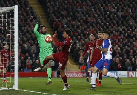Alisson Becker and Trent Alexander-Arnold of Liverpool clear the ball as Francisco Soares of FC Porto closes in during the UEFA Champions League match at Anfield, Liverpool. Picture date: 9th April 2019. Picture credit should read: Andrew Yates Sportimage EDITORIAL USE ONLY. No use with unauthorised audio, video, data, fixture lists, club league logos or live services. Online in-match use limited to 120 images, no video emulation. No use in betting, games or single club league player publications. SPI-0024-0030