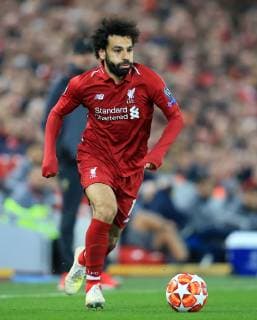 9th April 2019, Anfield, Liverpool, England; UEFA Champions League football, quarter final 1st leg, Liverpool versus FC Porto; Mohamed Salah of Liverpool spints forward with the ball as Liverpool manager Jurgen Klopp looks on  ActionPlus12122498 DavidxBlunsden