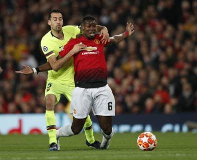 Sergio Busquets of Barcelona brings down Paul Pogba of Manchester United ManU during the UEFA Champions League match at Old Trafford, Manchester. Picture date: 10th April 2019. Picture credit should read: Darren Staples Sportimage EDITORIAL USE ONLY. No use with unauthorised audio, video, data, fixture lists, club league logos or live services. Online in-match use limited to 120 images, no video emulation. No use in betting, games or single club league player publications. SPI-0026-0027