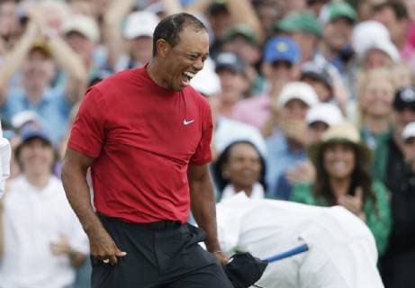 Tiger Woods celebrates on the 18th green in the final round at the 2019 Masters Tournament at Augusta National Golf Club in Augusta, Georgia, on April 14, 2019. Tiger Woods wins the Masters with a score of 13 under par for his 5th Green Jacket.  AUG20190414916 JOHNxANGELILLO