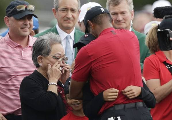 Tiger Woods hugs daughter Charlie while his son Sam and mom Kultida watch on the 18th green in the final round at the 2019 Masters Tournament at Augusta National Golf Club in Augusta, Georgia, on April 14, 2019. Tiger Woods wins the Masters with a score of 13 under par for his 5th Green Jacket.  AUG20190414918 JOHNxANGELILLO