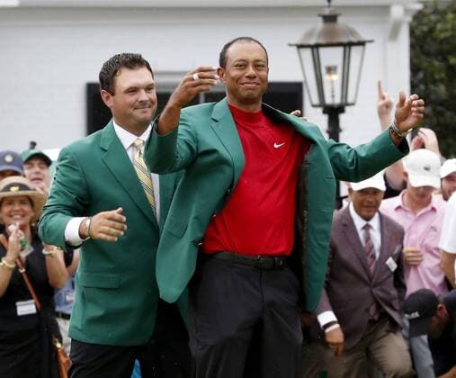 Golf: Masters Tournament Tiger Woods of the United States is awarded the Green Jacket by the previous year s Masters champion Patrick Reed after winning the 2019 tournament in Augusta, Georgia, on April 14, 2019 -- his first major championship in 11 years and his fifth-ever Masters victory. 