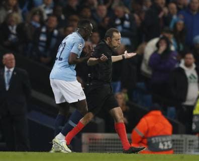 Benjamin Mendy of Manchester City remonstrates with referee Cuneyt Caker during the UEFA Champions League match at the Etihad Stadium, Manchester. Picture date: 17th April 2019. Picture credit should read: Darren Staples Sportimage EDITORIAL USE ONLY. No use with unauthorised audio, video, data, fixture lists, club league logos or live services. Online in-match use limited to 120 images, no video emulation. No use in betting, games or single club league player publications. SPI-0043-0032