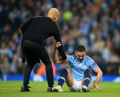 17th April 2019, Etihad Stadium, Manchester, England; UEFA Champions League football, quarter final 2nd leg, Manchester City versus Tottenham Hotspur; Manchester City manager Pep Guardiola helps a dejected Ilkay Gundogan of Manchester City to his feet after the final whistle  ActionPlus12125029 DavidxBlunsden