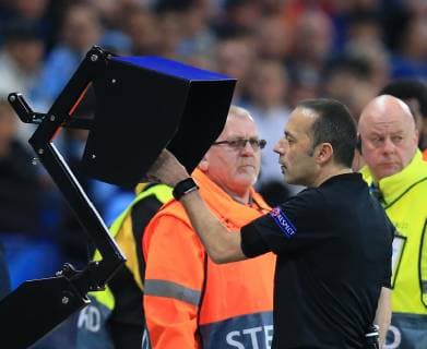 17th April 2019, Etihad Stadium, Manchester, England; UEFA Champions League football, quarter final 2nd leg, Manchester City versus Tottenham Hotspur; referee Cuneyt Cakir studies the VAR screen before disallowing the late goal of Raheem Sterling of Manchester City  ActionPlus12125036 DavidxBlunsden
