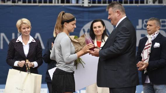 Tennis player Karolina Muchova, center, (Czech) takes a trophy for the 2nd place after lost final match against Jil Teichmann (Switzerland) from Ivo Kaderka, Director of the Czech Tennis Association, within the J&T Banka Prague Open, on May 4, 2019, in Prague, Czech Republic. On the left side is seen Petra Cernoskova, tennis coach and manager. (CTKxPhoto MichalxKamaryt) CTKPhotoP201905040340001  kmt 35