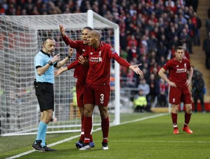 Liverpool s Virgil Van Dijk and Fabinho argue with referee Cuneyt Cakir during the UEFA Champions League match at Anfield, Liverpool. Picture date: 7th May 2019. Picture credit should read: Darren Staples Sportimage EDITORIAL USE ONLY. No use with unauthorised audio, video, data, fixture lists, club league logos or live services. Online in-match use limited to 120 images, no video emulation. No use in betting, games or single club league player publications. SPI-0072-0030