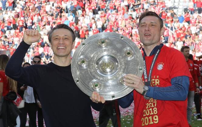 FC Bayern Munich becomes German Champion for the 7th time in a row against Eintracht Frankfurt FC Bayern is German Football Champion of the season 2018 2019 The coaches of FC Bayern with Champions Cup Niko Kovac and Robert Kovac Munich Bayern Germany Allianz Arena