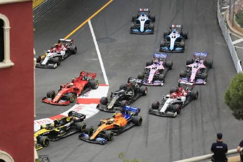 Driver field of the Formula 1 Grand Prix in the Principality of Monaco shortly after the start at the end of the start home straight and before the Ste Devote curve, Cote dÂ Azur, Mediterranean Sea