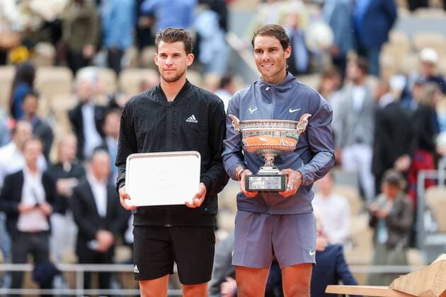 Rafael Nadal of Spain and Dominic Thiem of Austria pose with the trophy during the trophy ceremony after the men s singles final match of the French Open tennis tournament at the Roland Garros in Paris, France on June 9, 2019.  (105459467)
