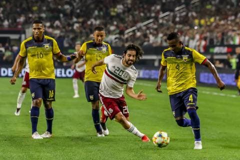ARLINGTON, TX - JUNE 09: Ecuador defender Pedro Pablo Velasco (4) dribbles the ball towards Mexico forward Rodolfo Pizarro (20), Ecuador midfielder Jefferson Intriago (15) and Ecuador midfielder Antonio Valencia (16) during the game on June 09, 2019 at AT&T Stadium in Arlington, Texas. (Photo by Matthew Pearce Icon Sportswire) SOCCER: JUN 09 Mexico v Ecuador Icon1691906092306