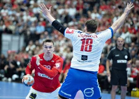 Denmarks Lasse Andersson walks past the Faeroe Islands Rogvi Dal Christiansen in the European Championship qualifiers in mens handball between Denmark and the Faeroese in Jutlander Bank Arena Aalborg, Sunday, June 16, 2019, Aalborg Jutland Denmark,  Copyright: HenningxBagger HenningxBaggerx COP101 spdk20190616-184907-L