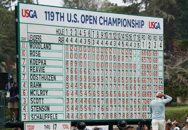 Brooks Koepka walks by the leaderboard on the 18th green in the final round of the 2019 U.S. Open at Pebble Beach Golf Links on June 16, 2019 in Pebble Beach, California. Gary Woodland wins the 2019 U.S. Open and his first major championship with a score of 13 under par.  PBP201906168184 KEVINxDIETSCH