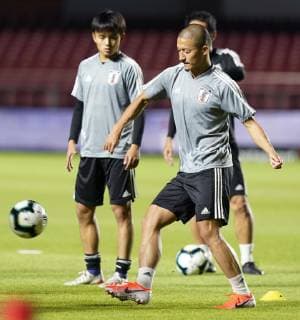 Football: Japan training for Copa America opener Real Madrid-bound Japan midfielder Takefusa Kubo (L) takes part in training in Sao Paulo, Brazil, on June 16, 2019, a day before the team s Copa America opener against Chile. 
