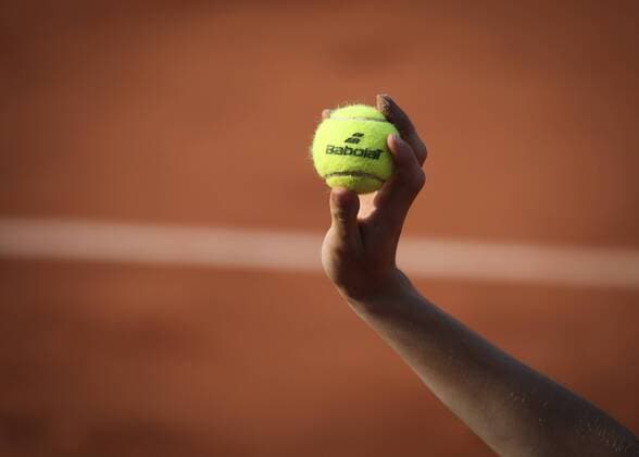 French Open Feature, Ballunge holds ball up with Babolat logo, close-up, detail, symbol photo Copyright: xJuergenxHasenkopfx