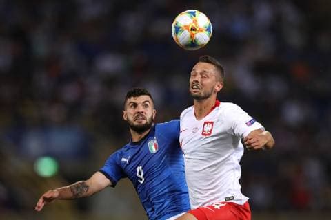 Mateusz Wieteska of Poland heads the ball back to the goalkeeper under pressure from Patrick Cutrone of Italy during the UEFA Under-21 Championship 2019 match at Renato Dall Ara, Bologna. Picture date: 19th June 2019. Picture credit should read: Jonathan Moscrop Sportimage EDITORIAL USE ONLY. No use with unauthorised audio, video, data, fixture lists, club league logos or live services. Online in-match use limited to 120 images, no video emulation. No use in betting, games or single club league player publications. SPI-0102-0006
