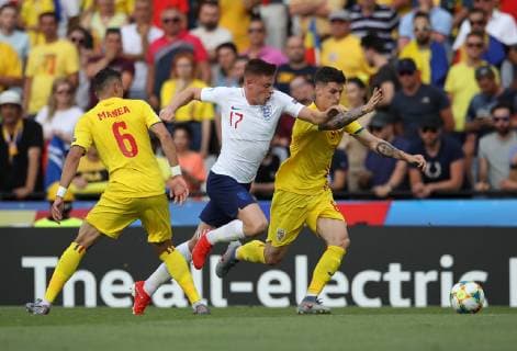 Harvey Barnes of England takes on Dennis Man of Romania during the UEFA Under-21 Championship 2019 match at San Marino Stadium, Serravalle. Picture date: 21st June 2019. Picture credit should read: Jonathan Moscrop Sportimage EDITORIAL USE ONLY. No use with unauthorised audio, video, data, fixture lists, club league logos or live services. Online in-match use limited to 120 images, no video emulation. No use in betting, games or single club league player publications. SPI-0103-0007