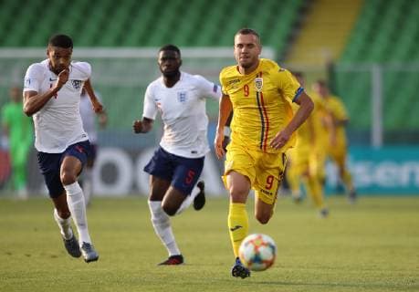 George Puscas of Romania runs through Jake Clarke-Salter of England during the UEFA Under-21 Championship 2019 match at San Marino Stadium, Serravalle. Picture date: 21st June 2019. Picture credit should read: Jonathan Moscrop Sportimage EDITORIAL USE ONLY. No use with unauthorised audio, video, data, fixture lists, club league logos or live services. Online in-match use limited to 120 images, no video emulation. No use in betting, games or single club league player publications. SPI-0103-0013
