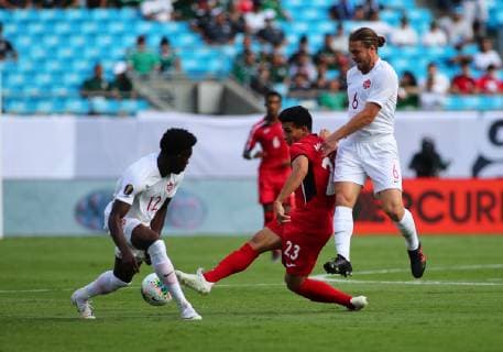 CHARLOTTE, NC - JUNE 23: Cuba midfielder Luis Paradela (23) kicks the ball through Cuba goalkeeper Elier Pozo (12) legs while Cuba defender Yosel Piedra (6) is on top of him during the 1st half of the CONCACAF Gold Cup game with Canada versus Cuba on June 23rd, 2019, at Bank of America Stadium in Charlotte, NC. (Photo by Jaylynn Nash Icon Sportswire) SOCCER: JUN 23 CONCACAF Gold Cup Group A - Canada v Cuba Icon19062300018