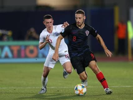 Nikola Vlasic of Croatia challenged by Phil Foden of England during the UEFA Under-21 Championship 2019 match at San Marino Stadium, Serravalle. Picture date: 24th June 2019. Picture credit should read: Jonathan Moscrop Sportimage EDITORIAL USE ONLY. No use with unauthorised audio, video, data, fixture lists, club league logos or live services. Online in-match use limited to 120 images, no video emulation. No use in betting, games or single club league player publications. SPI-0105-0018
