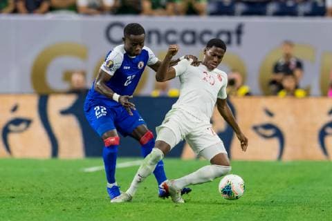 June 29, 2019 - Houston, Texas, USA - June 29, 2019 : Haiti defender Alex Christian (22) and Canada forward Jonathan David (20) battle for the ball during a Concacaf Gold Cup Quarterfinals match between Haiti vs Canada at NRG Stadium in Houston, Texas. The final Haiti wins 3-2. ZUMA Press CONCACAF Gold Cup Quarterfinals 2019: Haiti vs Canada Jun 29 - ZUMAl153 20190629_zap_l153_030 Copyright: xMariaxLysakerx
