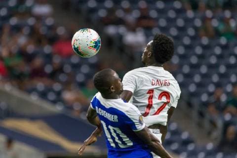 HOUSTON, TX - JUNE 29: Wilde-Donald Guerrier (10) of Haiti and Alphonso Davies (12) of Canada leap for the ball during the Quarterfinals match between Haiti and Canada as part of the 2019 CONCACAF Gold Cup on June 29, 2019, at NRG Stadium in Houston, Texas. (Photo by David Buono Icon Sportswire) SOCCER: JUN 29 CONCACAF Gold Cup Quarterfinals - Haiti v Canada Icon190629014