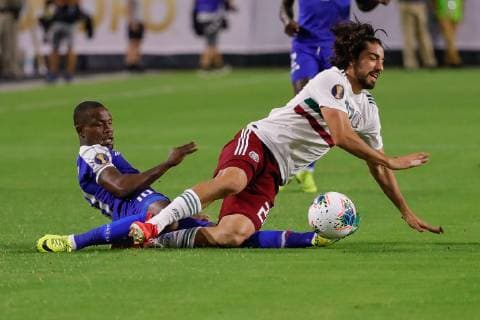 GLENDALE, AZ - JULY 02: Haiti midfielder Wilde-Donald Guerrier (10) tackles Mexico forward Rodolfo Pizarro (20) during the CONCACAF Gold cup semifinal soccer game between Haiti and Mexico on July 2, 2019 at State Farm Stadium in Glendale, Arizona. (Photo by Kevin Abele Icon Sportswire) SOCCER: JUL 02 CONCACAF Gold Cup Semifinals - Haiti v Mexico Icon190702011