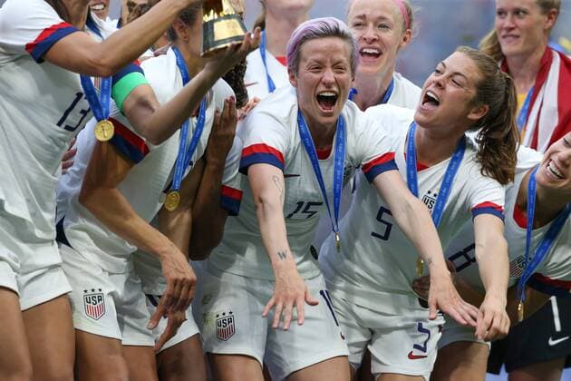 Megan Rapinoe and Kelley O Hara of USA celebrate with the trophy after the FIFA Women s World Cup match at Stade de Lyon, Lyon. Picture date: 7th July 2019. Picture credit should read: Jonathan Moscrop Sportimage EDITORIAL USE ONLY. No use with unauthorised audio, video, data, fixture lists, club league logos or live services. Online in-match use limited to 120 images, no video emulation. No use in betting, games or single club league player publications. SPI-0113-0295