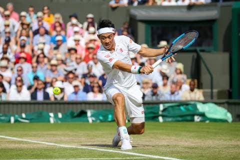 Kei Nishikori of Japan during the men s singles quarter-final match of the Wimbledon Lawn Tennis Championships against Roger Federer of Switzerland at the All England Lawn Tennis and Croquet Club in London, England on July 10, 2019.  (107695379)