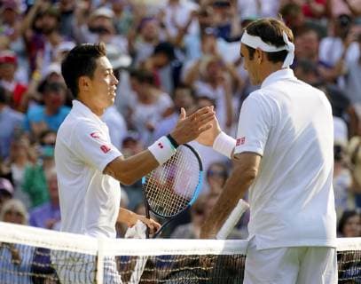Tennis: Wimbledon championships Japan s Kei Nishikori (L) and Roger Federer of Switzerland shake hands after the latter s win in the quarterfinals at Wimbledon on July 10, 2019. 