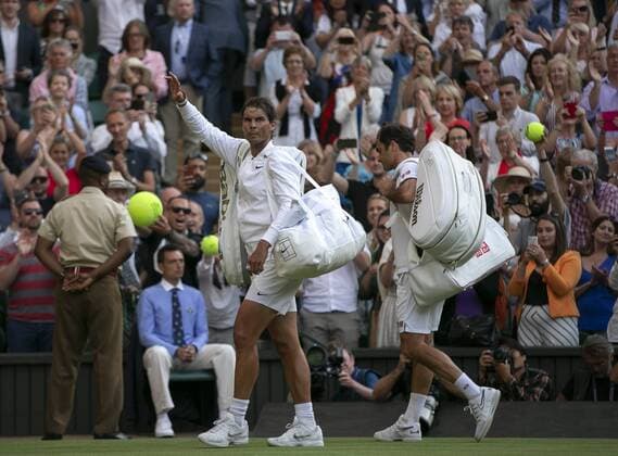 (190713) -- LONDON, July 13, 2019 -- Roger Federer of Switzerland and Rafael Nadal (L) of Spain leave the court after their men s singles semi-final match at the 2019 Wimbledon Tennis Championships in London, Britain, on July 12, 2019. Roger Federer won 3-1. ) (SP)BRITAIN-LONDON-TENNIS-WIMBLEDON-DAY 11 HanxYan 