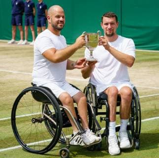 Belgian Joachim Gerard (R) and Swedish Stefan Olsson celebrate with the cup as they won the final of the men s wheelchair doubles final against British pair Alfie Hewitt and Gordon Reid at the 2019 Wimbledon grand slam tennis tournament at the All England Tennis Club, in south-west London, Britain, Saturday 13 July 2019. PETERxVANxDENxBERG  x05625362x