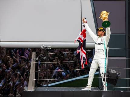 14th July 2019; Silverstone Circuit, Northampton, England; FIA F1 Grand Prix of Britain, Race Day; Mercedes AMG Petronas Motorsport driver Lewis Hamilton wshows the winners trophy to the fans  ActionPlus12153911 TimxWilliams