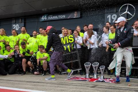 14th July 2019; Silverstone Circuit, Northampton, England; FIA F1 Grand Prix of Britain, Race Day; Mercedes AMG Petronas Motorsport driver Lewis Hamilton sprays the champgane over his team  ActionPlus12153913 TimxWilliams