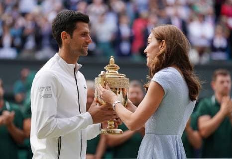 Serbian Novak Djokovic receives the winners trophy from the Duchess of Cambridge after victory in the Men s Singles Final match against Swiss Roger Federer at Wimbledon on Sunday, July 14, 2019. Djokovic won the match 7-6,1-6,7-6,4-6,13-12.  LON2019071404 HUGOxPHILPOTT