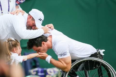Gustavo Fernandez of Argentina kisses his daughter after winning the men s wheelchair singles final match of the Wimbledon Lawn Tennis Championships against Shingo Kunieda of Japan at the All England Lawn Tennis and Croquet Club in London, England on July 14, 2019.  (107962058)