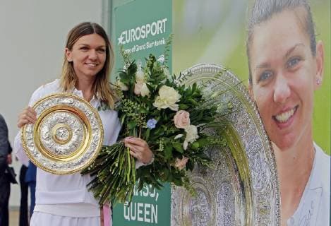 (190716) -- BUCHAREST, July 16, 2019 -- Romanian tennis player Simona Halep, 2019 Wimbledon Women s singles champion, poses with her trophy next to a banner of herself as she arrives at the Henry Coanda International Airport in Bucharest, capital of Romania, July 15, 2019. Cristian Cristel) (SP)ROMANIA-BUCHAREST-TENNIS-HALEP-ARRIVAL LinxHuifen 