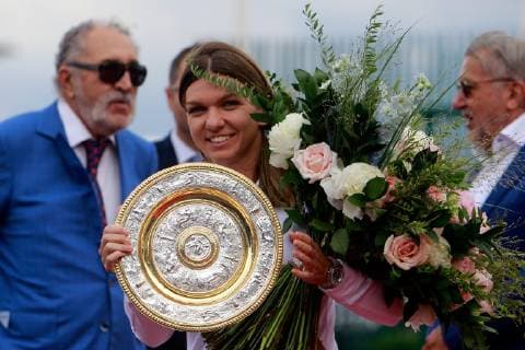 (190716) -- BUCHAREST, July 16, 2019 -- Romanian tennis player Simona Halep, 2019 Wimbledon Women s singles champion, poses with her trophy as she arrives at the Henry Coanda International Airport in Bucharest, capital of Romania, July 15, 2019. Cristian Cristel) (SP)ROMANIA-BUCHAREST-TENNIS-HALEP-ARRIVAL LinxHuifen 