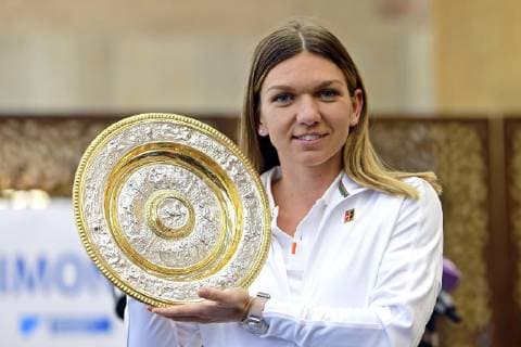 (190716) -- BUCHAREST, July 16, 2019 -- Romanian tennis player Simona Halep, 2019 Wimbledon Women s singles champion, poses with her trophy as she arrives at the Henry Coanda International Airport in Bucharest, capital of Romania, July 15, 2019. Cristian Cristel) (SP)ROMANIA-BUCHAREST-TENNIS-HALEP-ARRIVAL LinxHuifen 