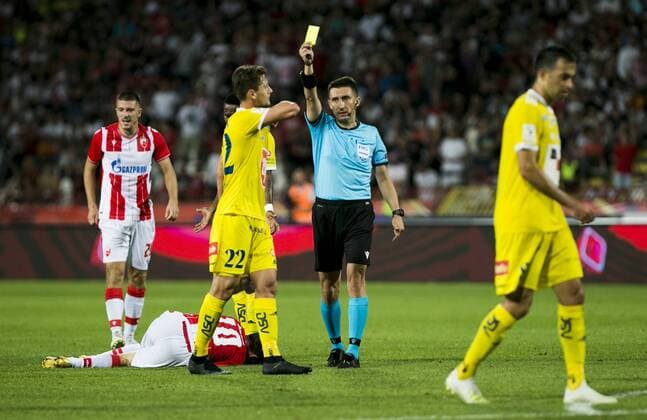 24th July 2019; Rajko Mitic Stadium, Belgrade, Serbia; UEFA Champions League Qualifying Second Leg First Round Red Star Belgrade versus HJK Helsinki; Referee Pawel Gil of POL gives a yellow card to Kairinen of HJK Helsinki for a poor tackle  ActionPlus12156235 NikolaxKrstic