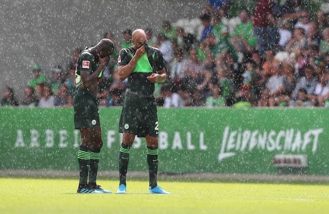 Josuha Guilavogui VfL Wolfsburg and John Anthony Brooks VfL Wolfsburg in heavy rain DFL REGULATIONS PROHIBIT ANY USE OF PHOTOGRAPHS AS IMAGE SEQUENCES AND OR QUASI VIDEO
