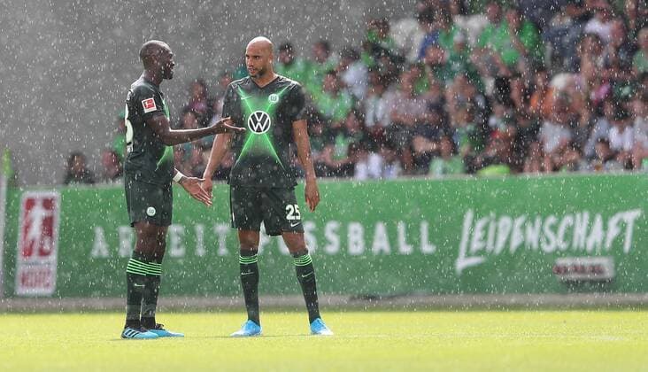 Josuha Guilavogui VfL Wolfsburg and John Anthony Brooks VfL Wolfsburg in heavy rain DFL REGULATIONS PROHIBIT ANY USE OF PHOTOGRAPHS AS IMAGE SEQUENCES AND OR QUASI VIDEO