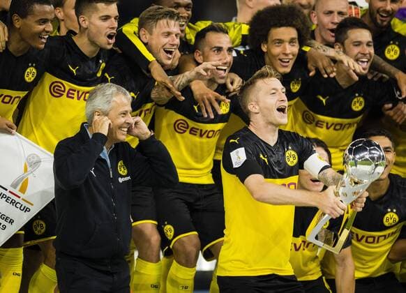Dortmund, 03 08 2019 Marco Reus BvB lifts the trophy in the air and coach Lucien Favre BvB holds his ears to Borussia Dortmund FC Bayern Munich