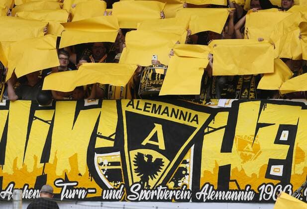 Aachen, Germany, DFB Pokal, Alemannia Aachen Bayer Leverkusen 1 4 on 10 08 2019 at the Tivoli Stadium in Aachen An Ultra fan is filming or photographing with his smartphone during the choreography of the fan block In accordance with the requirements of the DFL Deutsche Fußball Liga, it is forbidden to exploit or have exploited photographs taken in the stadium and or from the match in the form of sequence images and or video-like photo sequences