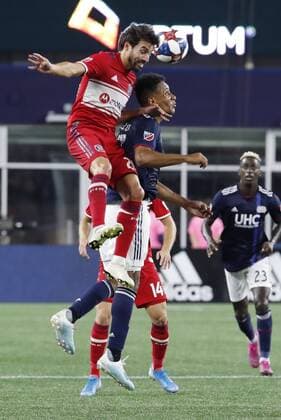 FOXBOROUGH, MA - AUGUST 24: Chicago Fire midfielder Nicolas Gaitan (20) wins the air battle over New England Revolution forward Juan Agudelo (17) during a match between the New England Revolution and the Chicago Fire on August 24, 2019, at Gillette Stadium in Foxborough, Massachusetts. (Photo by Fred Kfoury III Icon Sportswire) SOCCER: AUG 24 MLS, Fussball Herren, USA - Chicago Fire at New England Revolution Icon482190824033