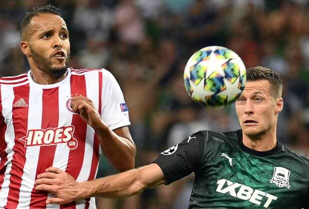 KRASNODAR, RUSSIA - AUGUST 27, 2019: Olympiacos FC s Youssef El Arabi (L) and FC Krasnodar s Uros Spajic in the senond leg of the 2019-20 UEFA Champions League play-off football match between FC Krasnodar and Olympiacos FC at Krasnodar Stadium; Olympiacos FC won 2-1. Maxim Romanov TASS  TS0B8367
