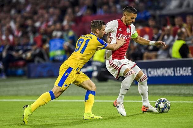 AMSTERDAM , 29-08-2019 , Johan Cruijff ArenA , Champions League playoff, season 2019-2020 , APOEL Nicosia player Dragan Mihajlovic, Ajax player Dusan Tadic during the match Ajax - APOEL Nicosia Ajax - APOEL Nicosia  x4211476x Copyright: