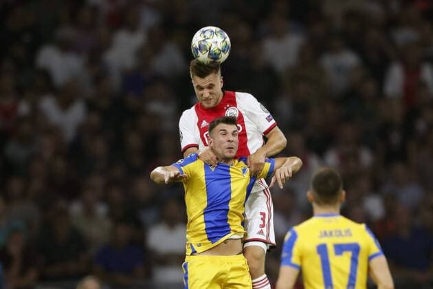 (L-R) Joel Veltman of Ajax, Andrija Pavlovic of APOEL FC during the UEFA Champions League play off qualifying second leg match between Ajax Amsterdam and APOEL FC at the Johan Cruijff Arena on August 28, 2019 in Amsterdam, The Netherlands UEFA Champions League 2019 2020 xVIxVIxImagesx xMauricexvanxSteenxIVx 201349752