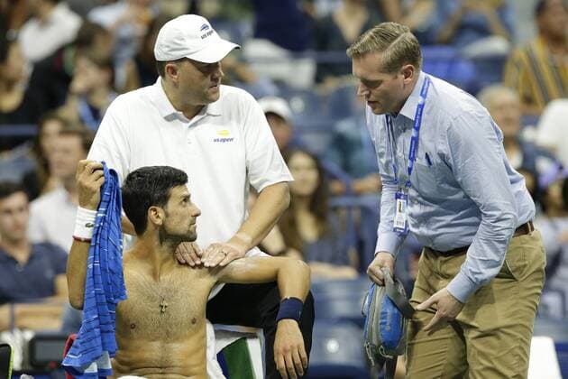 Novak Djokovic of Serbia receives treatment on the court during a changeover in his second round match against Juan Ignacio Londero of Argentina in Arthur Ashe Stadium at the 2019 US Open Tennis Championships at the USTA Billie Jean King National Tennis Center on Wednesday, August 28, 2019 in New York City.  NYP20190828205 JOHNxANGELILLO